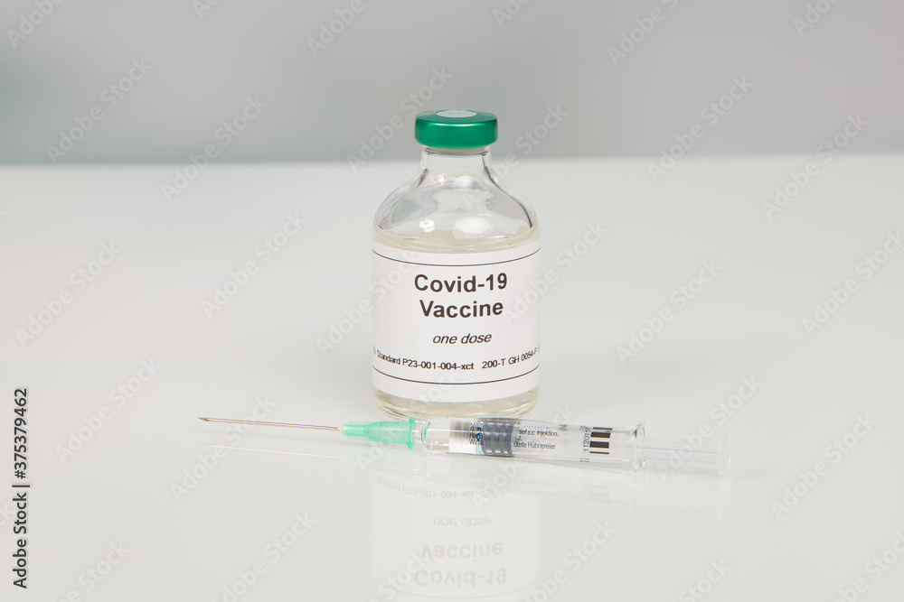 Close up of a syringe and a Covid-19 serum/vaccine bottle Close up of a syringe and a Covid-19 serum/vaccine bottle