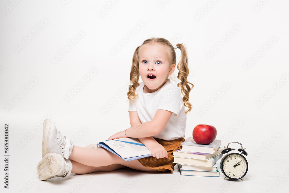 Beautiful shocked young girl lying on the floor isolated on white background Beautiful shocked young girl lying on the floor isolated on white background
