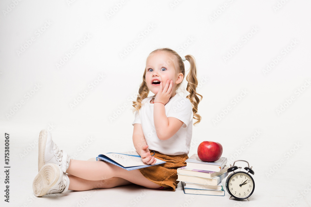 Beautiful shocked young girl lying on the floor isolated on white background Beautiful shocked young girl lying on the floor isolated on white background