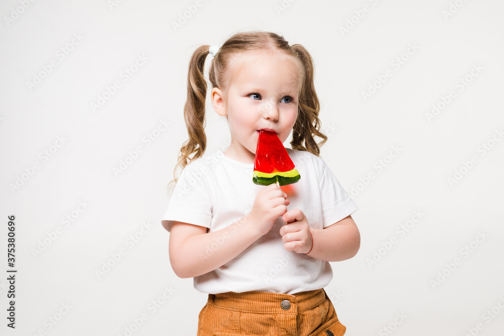 Impressing fact sugar nutrition. Girl child smiling holds lollipop candy. Girl kid with lollipop looks happy. Healthy nutrition and dieting concept. Sweet tooth concept. Baby happy face eat lollipop. Impressing fact sugar nutrition. Girl child smiling holds lollipop candy. Girl kid with lollipop looks happy. Healthy nutrition and dieting concept. Sweet tooth concept. Baby happy face eat lollipop.