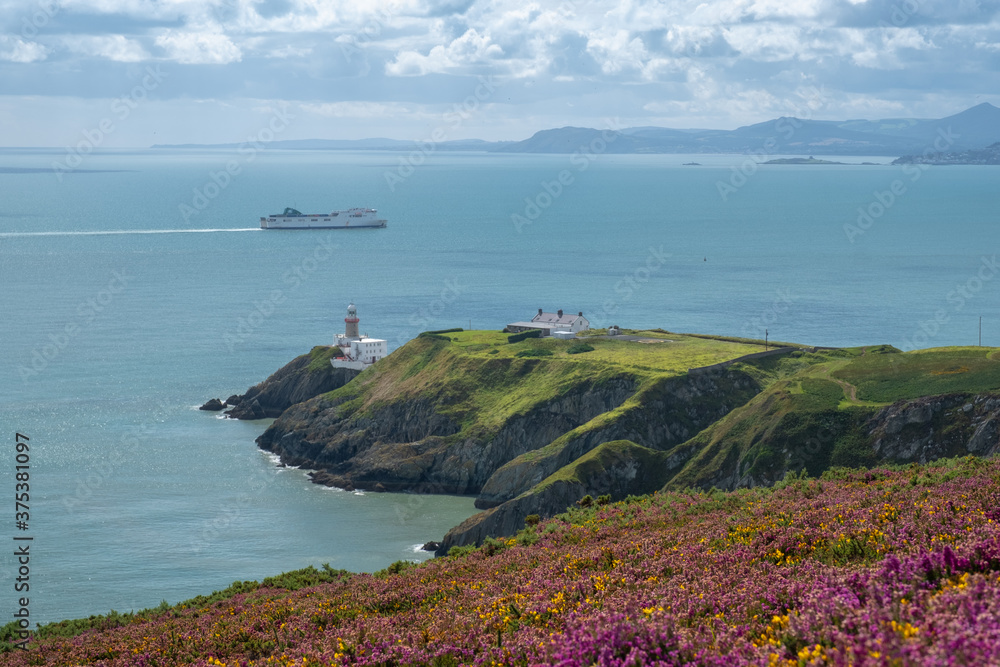 Baily lighthouse with ferry crossing in the background. Howth, Dublin,Ireland. August 2020