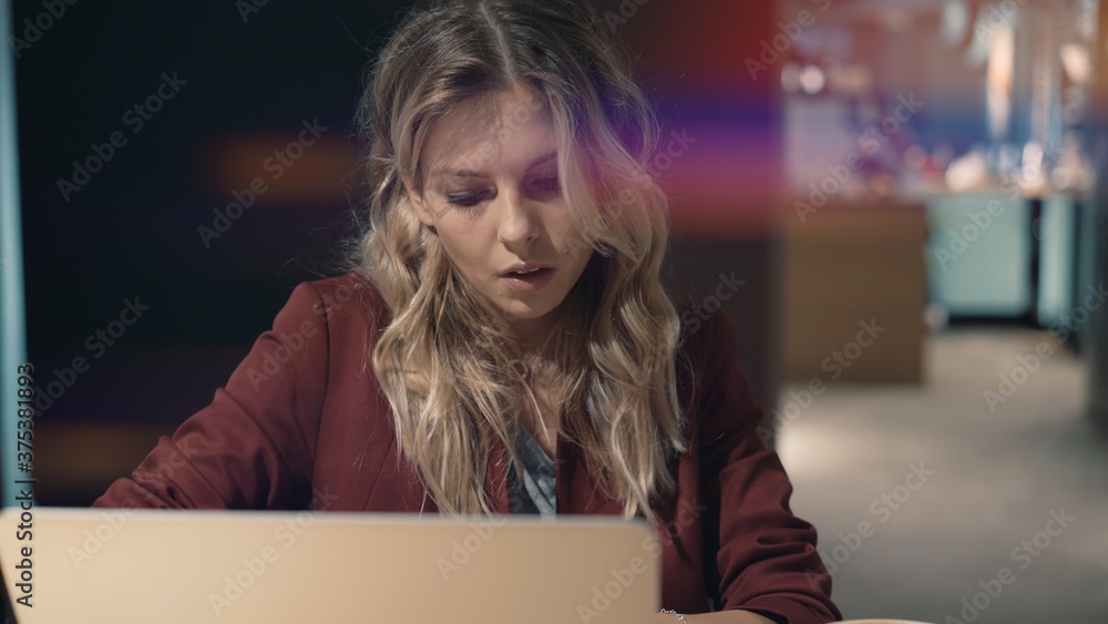 Attractive woman in cafe browsing the Internet using laptop and waiting some meeting with friend.. High quality photo. Lense flare Attractive woman in cafe browsing the Internet using laptop and waiting some meeting with friend.. High quality photo. Lense flare