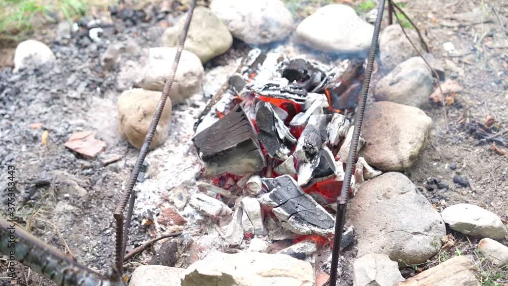 Getting coal from a fire to cook food Getting coal from a fire to cook food