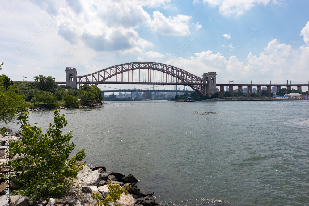 Fototapeta premium The Hell Gate Bridge along the Astoria Queens New York Riverfront over the East River during Summer