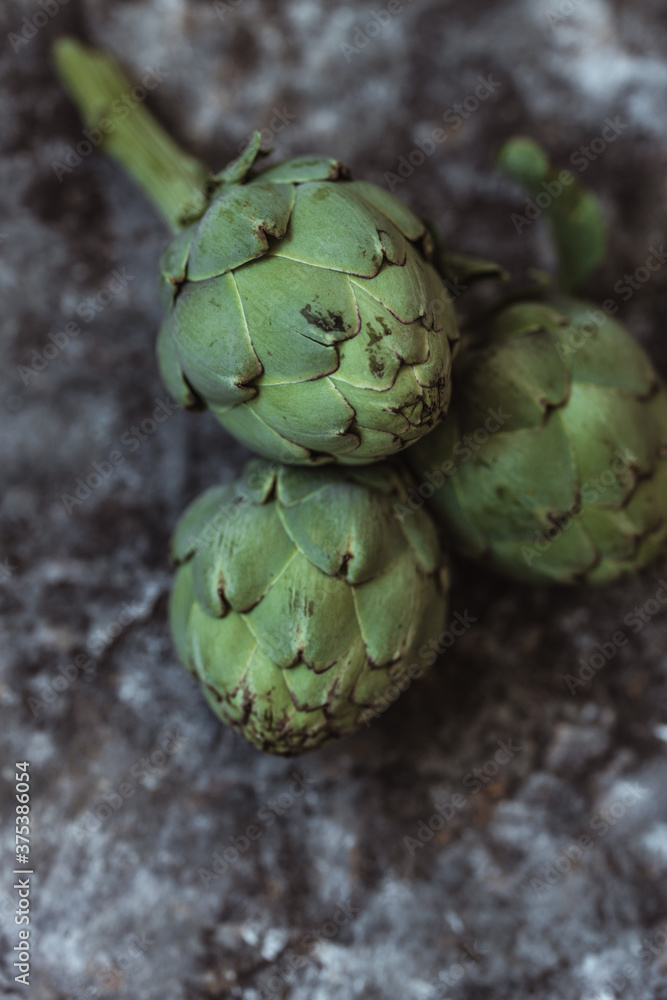 Fototapeta premium Fresh green artichokes. Top view. Copy space