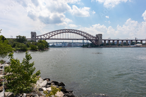 The Hell Gate Bridge along the Astoria Queens New York Riverfront over the East River during Summer