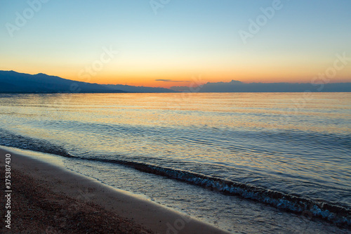 Wallpaper Mural Dawn of the sun at sea. The rising sun behind the mountains. Kyrgyzstan. Torontodigital.ca