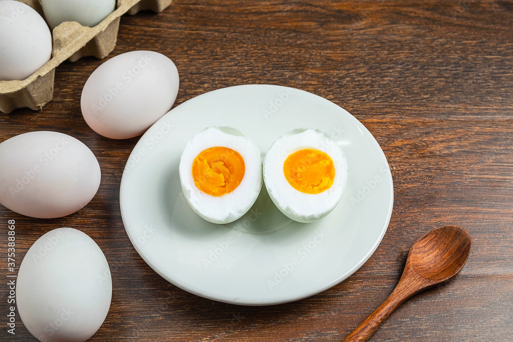 White duck eggs and salted egg food on a wooden table White duck eggs and salted egg food on a wooden table
