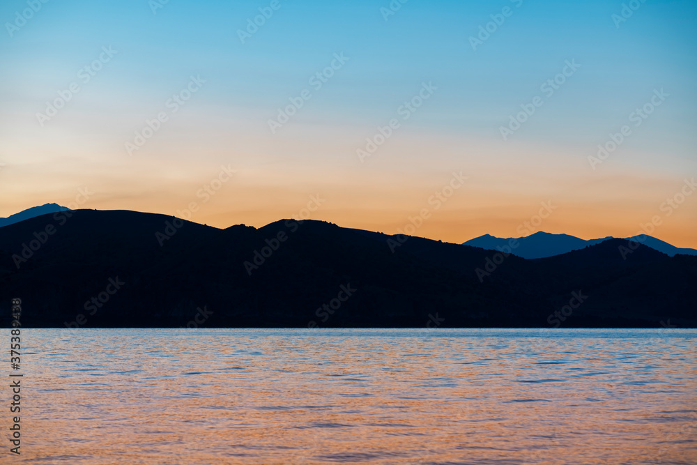 Beautiful sunrise landscape. The Mountains and lake early morning. Sevan National park Armenia.