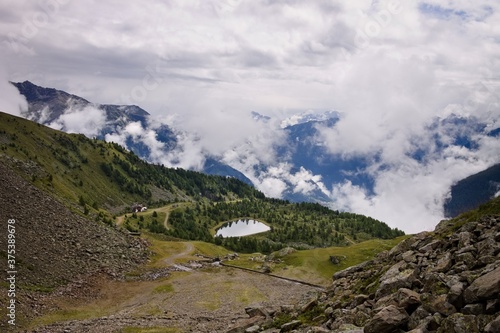 A small lake surrounded by a wood in the italian Alps near a mountain refuge  Trentino  Italy  Europe 