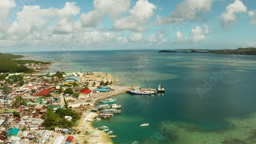 Freight ships and ferries in the bay, top view. Dapa Ferry Terminal. Siargao, Philippines. photo