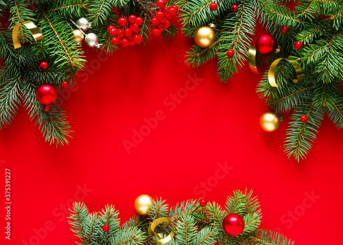 Christmas red background with christmas decorations, top view with space for text.