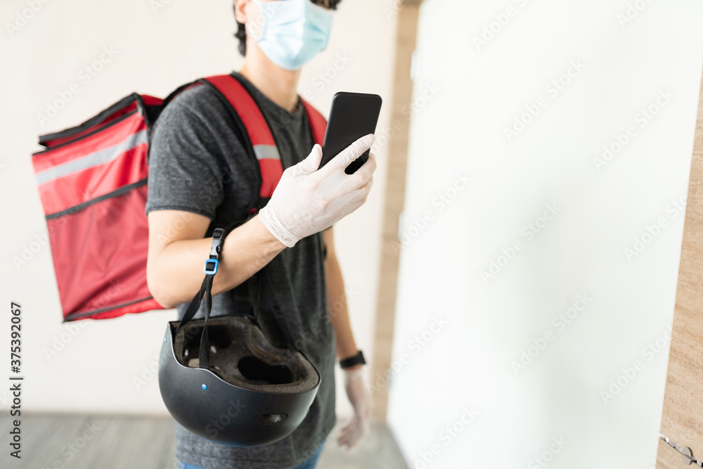 Delivery Man Using Mobile Phone In Building Delivery Man Using Mobile Phone In Building