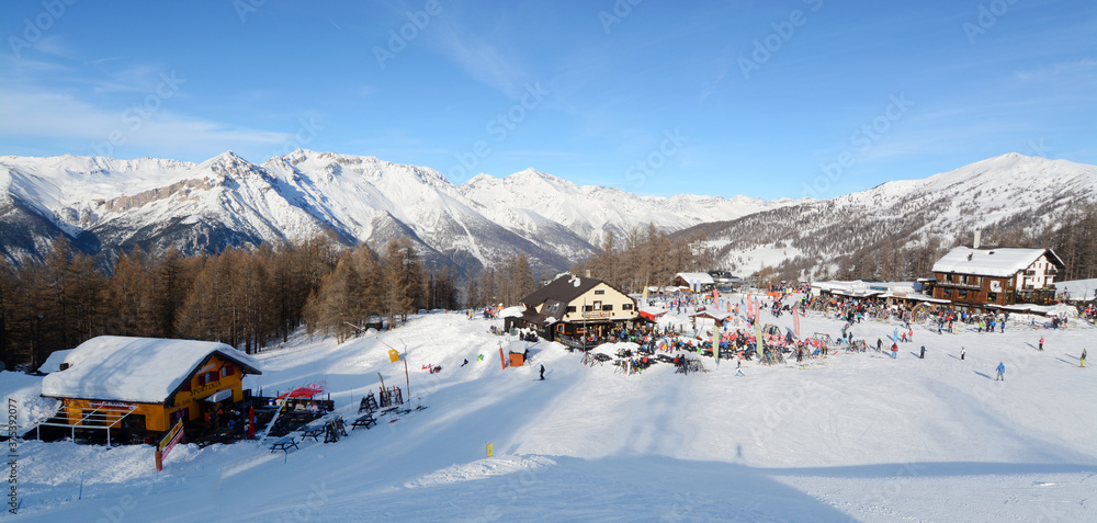 the winter sports resort of Sportinia (2137 m) is located on a shelf partially covered by conifers on which there are hotels, chalets and ski resorts. - obrazy, fototapety, plakaty 