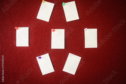 collection of note papers pinned on a red board ready for filling in quotes.