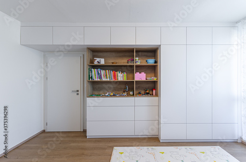 Foto Cabinet shelf wardrobe in Children's room with toys and books
