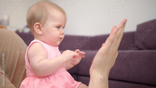Beautiful baby playing with dad hands. Happy time with father. Sweet childhood