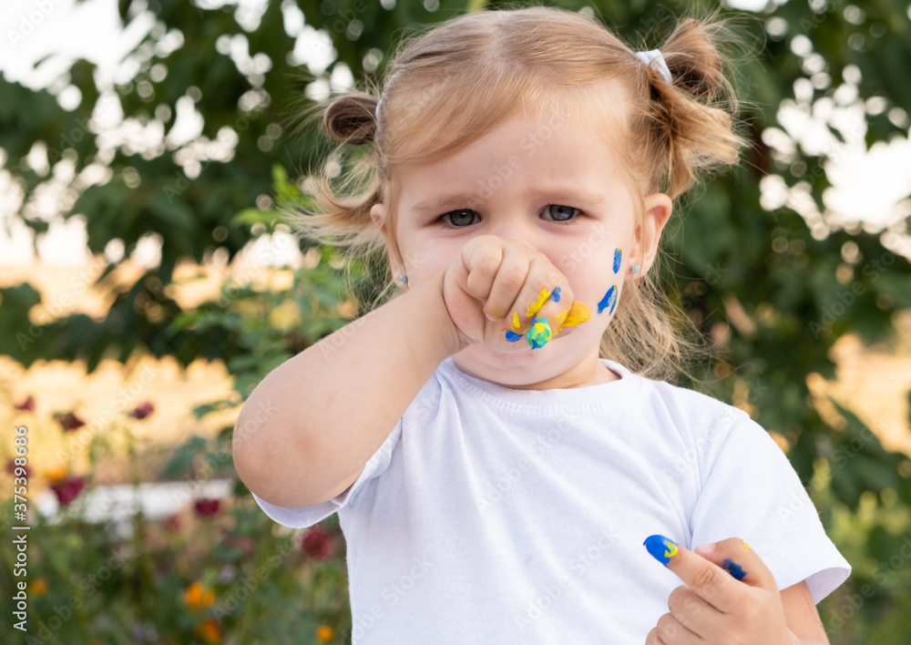 beautiful sweet upset girl with paint on her face. beautiful sweet upset girl with paint on her face.