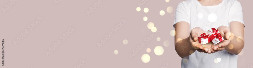 Boxing day, banner design. Woman with gifts on beige background, closeup and space for text Boxing day, banner design. Woman with gifts on beige background, closeup and space for text