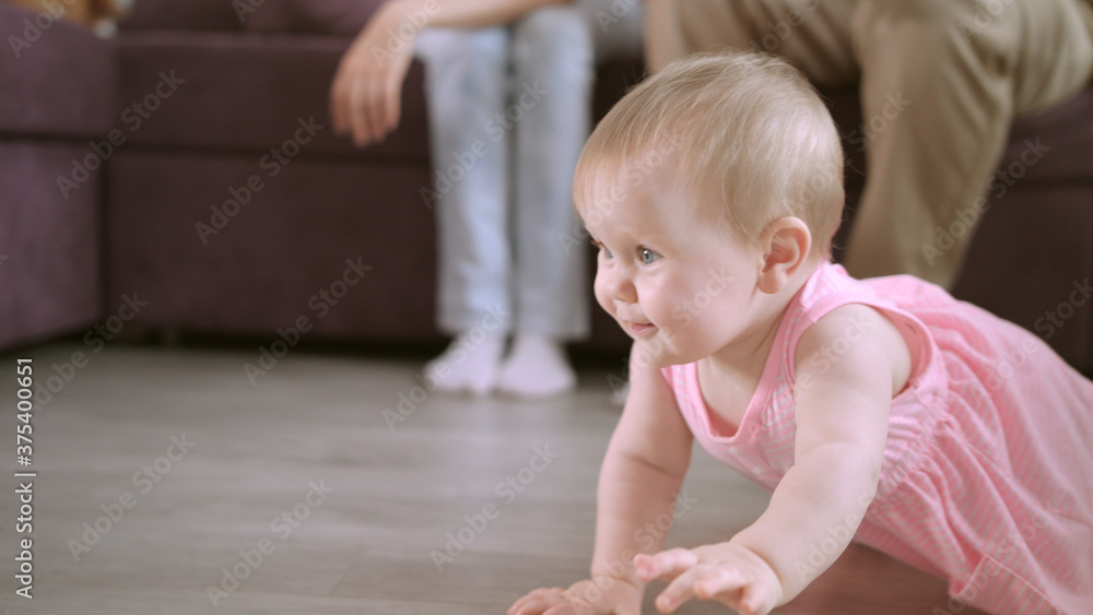 Beautiful baby crawling on floor at home. Happy family concept Beautiful baby crawling on floor at home. Happy family concept
