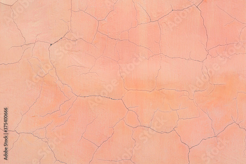 Fotografie Old cracked pink wall as background