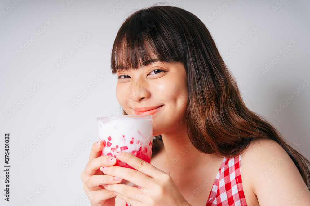 Young asian woman holding glass of sweet water chestnut dessert. Young asian woman holding glass of sweet water chestnut dessert.