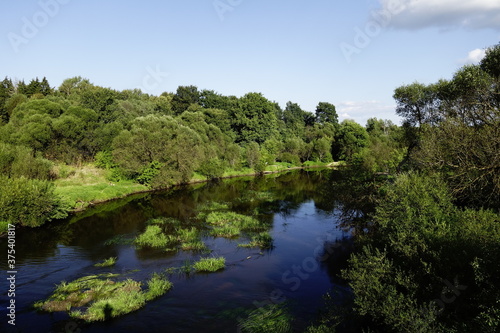 Landscape with a shallow river on a warm sunny August day in the country