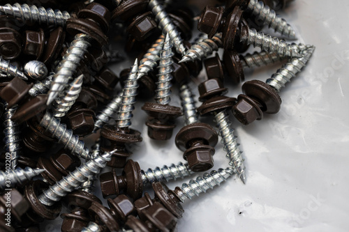 Pile of brown roofing screws in a hardware store photo