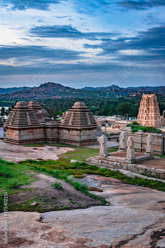 hampi ruins ancient stone art with dramatic sky flat angle shot photo