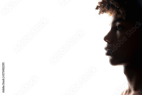 Black man silhouette. Masculine strength. Profile portrait of powerful african guy isolated on white closeup copy space. Freedom mind. Human tolerance. Ethnic problems photo