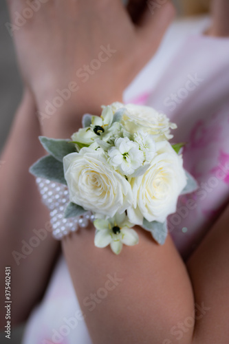 Photography White and green wrist corsage on a hand. Holy commiunion