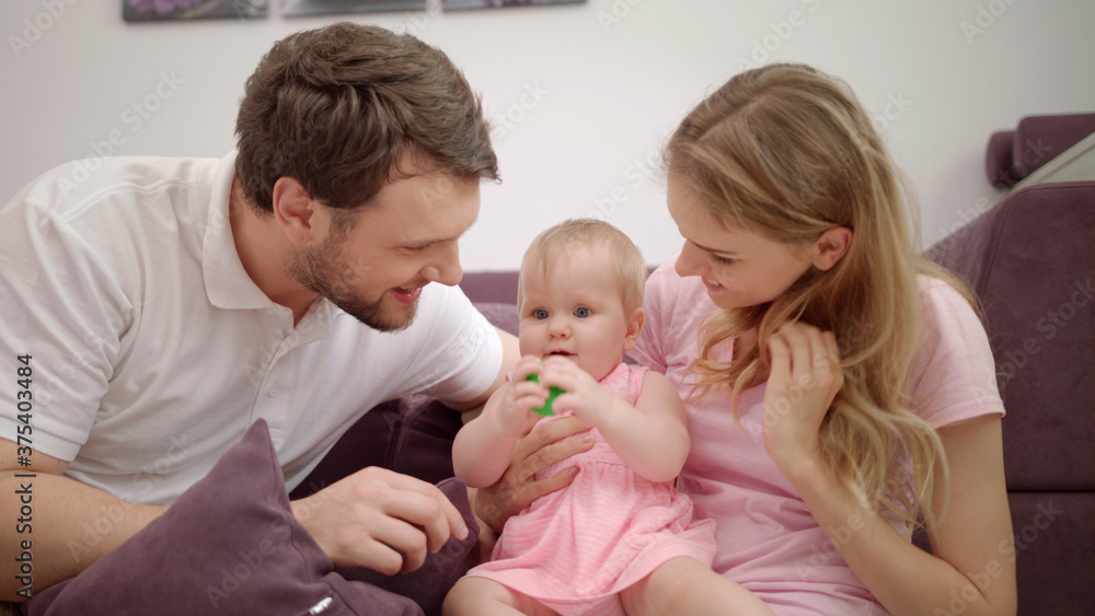 Happy family playing together. Joyful family with baby embrace