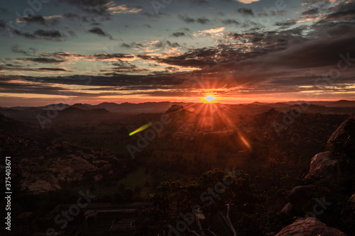 rocky mountain sunrise flares with dramatic sky at morning flat angle shot