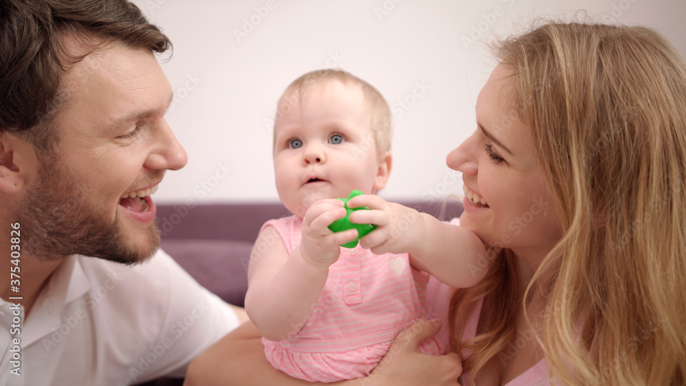 Beautiful family with baby. Sweet family love. Mom and dad kissing child girl Beautiful family with baby. Sweet family love. Mom and dad kissing child girl