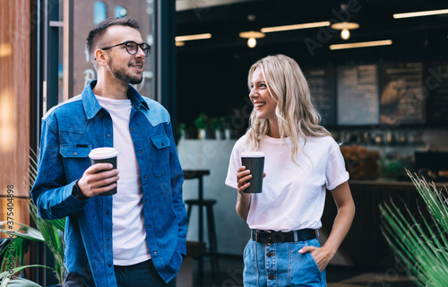 Konstfotografi Happy positive woman and man friends enjoying spending time together talking wit