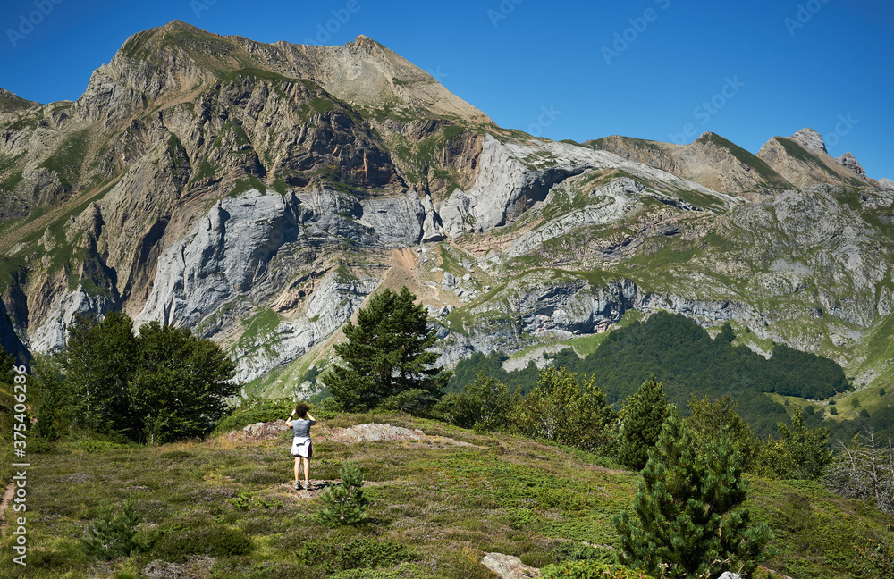 Woman walking through a mountain landscape