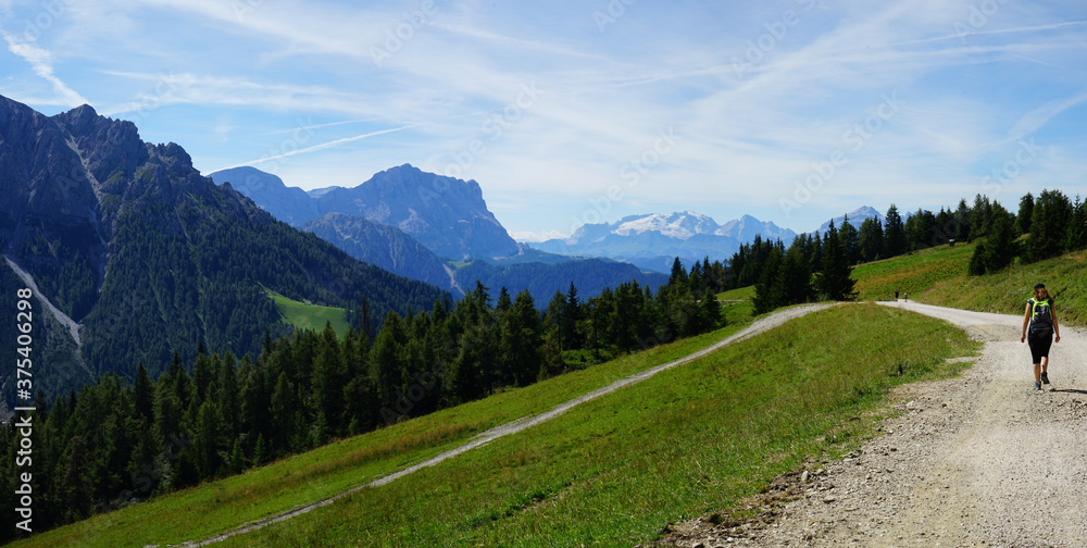 Girl walking on a mountain road in Plan de Corones, Sudtirol, Trentino Alto Adige, Dolomites, Italy