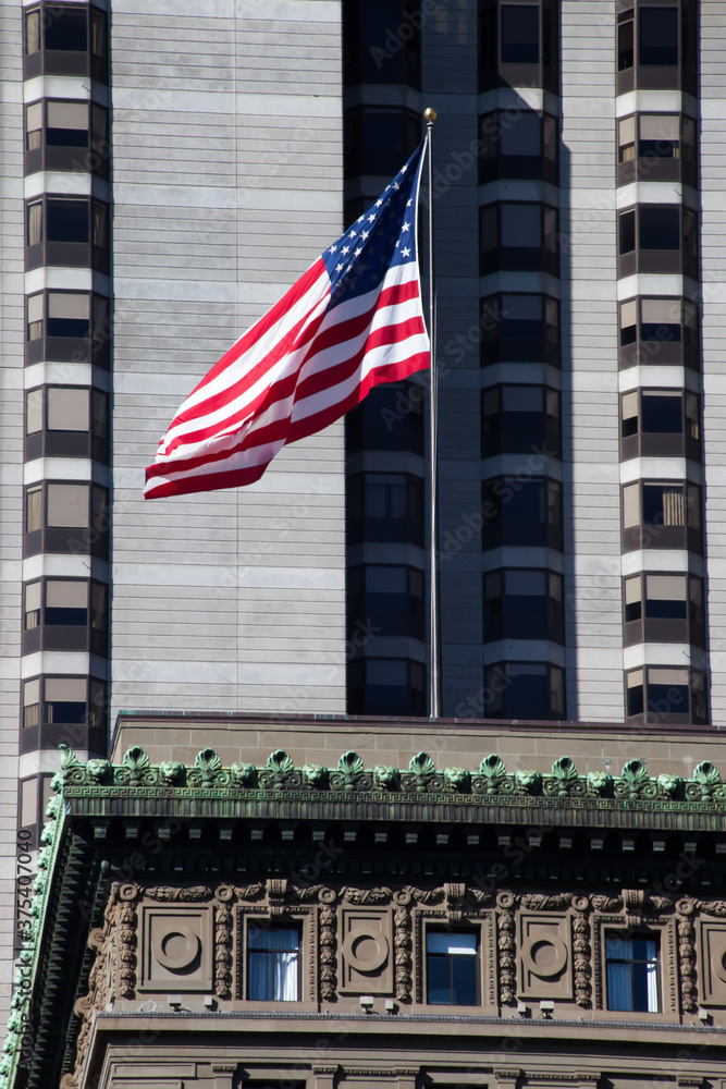 United States Flag with a building in the background