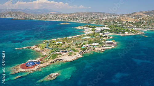 defaultAerial panoramic view of famous Grand Resort Lagonisi or Lagonissi paradise peninsula and beach with pool facilities in exotic peninsula, Athens riviera, Attica, Greece © aerial-drone