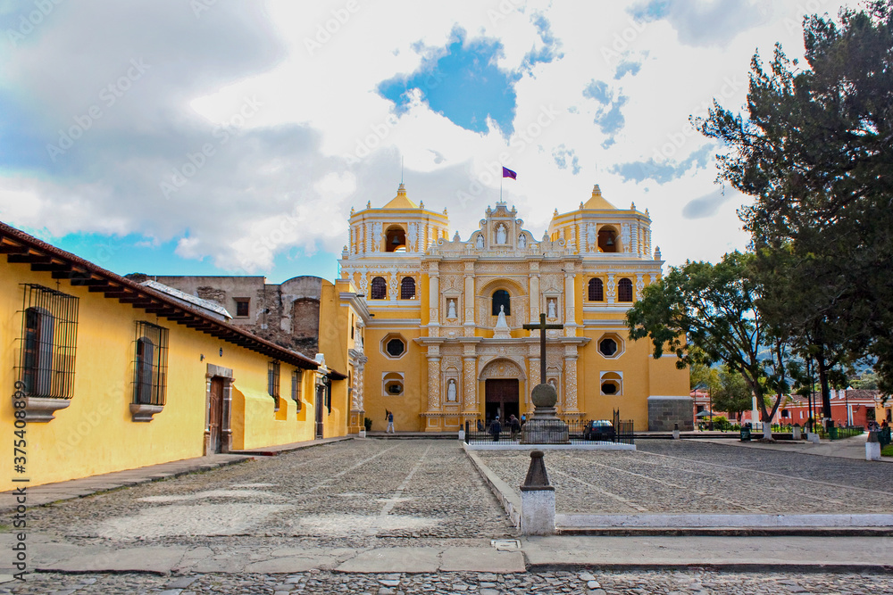 Iglesia De La Merced and cobblestone paved plaza with cross, Antigua, Guatemala