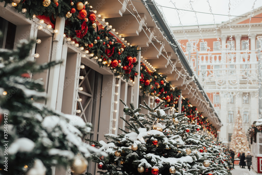Premises with decorated glowing Christmas trees and bright outdoor decorations. Christmas and New Year holidays.
