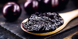 toast with grape jam, on rustic wooden table. Jabuticaba, exotic Brazilian fruit, used in cooking, as a sweet.