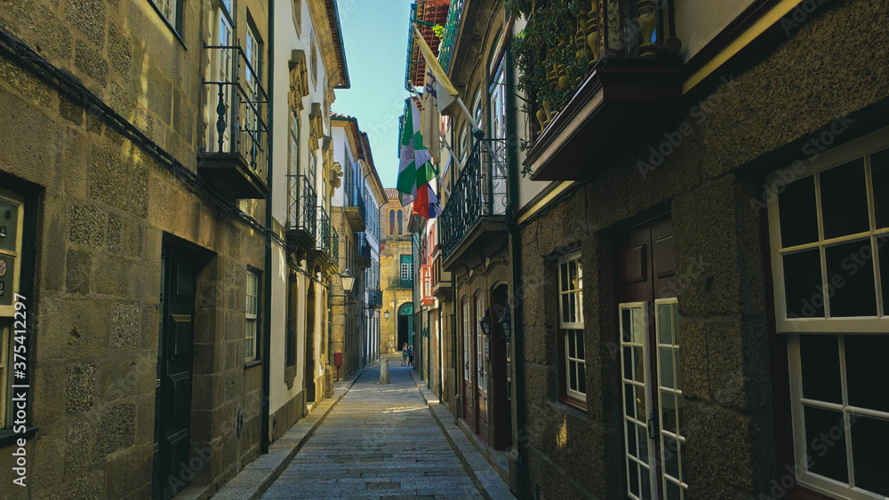 Guimarães street located in the historic center with flags and houses, Portugal.