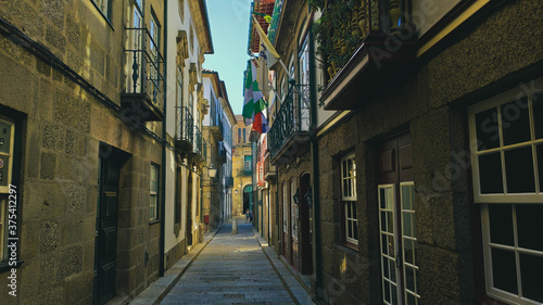 Guimar  es street located in the historic center with flags and houses  Portugal.