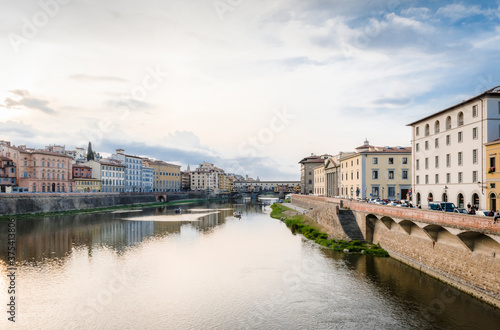 View of the river Arno, Ponte Vecchio bridge and pleasure boats in Florence in the evening in watercolor tones