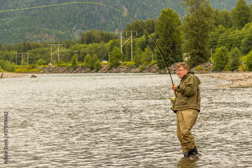 A fly fisherman hooked into a salmon on the Kitimat River, in British Columbia