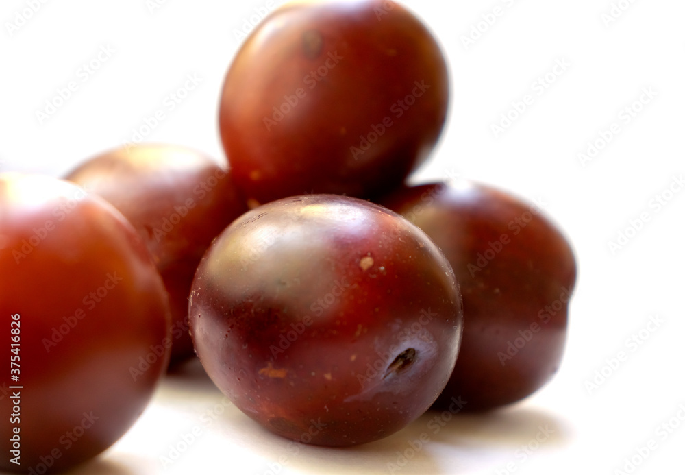 Delicious ripe plum berry dessert on white background raw food Delicious ripe plum berry dessert on white background raw food