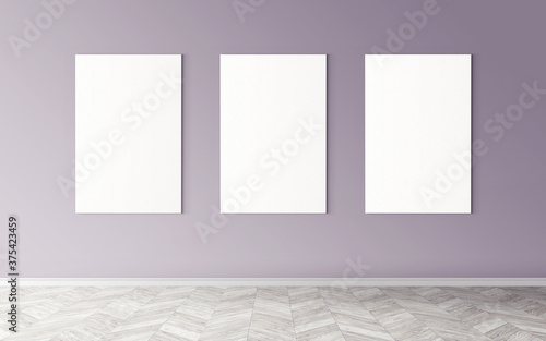 Three white empty canvases on wall. Mockup for you design preview. Good use for advertising materials.