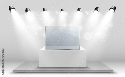 Glass showcase for the exhibition in the form of a cube. Background for sale illuminated by spotlights. Museum glass box isolated advertising or business design boutique. Exhibition hall.