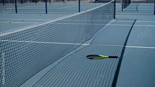 Stressed tennis player throwing and breaking a racket in anger and rage at court to net. Human emotions, defeat, crash, failure, loss concept. Professional Athlete Training, motivational video.